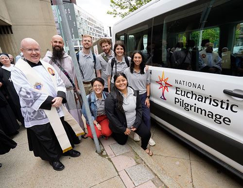 Father Roger Landry gathers with the team of perpetual pilgrims walking the Seton Route after blessing their support vehicle outside the Blessed Michael McGivney Pilgrimage Center in New Haven, Conn., on May 18.