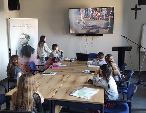 Ukrainian children watch a Bible story during a Greek Catholic catechism class at McGivney House in Radom, Poland, in May. 