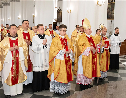 Father Konrad Szymański (center) prays during his ordination Mass, celebrated by Bishop Stanislav Shyrokoradiuk on May 27, 2023, in the Cathedral of the Assumption of the Blessed Virgin Mary in Odesa, Ukraine. (Courtesy of the Roman Catholic Church in Ukraine)