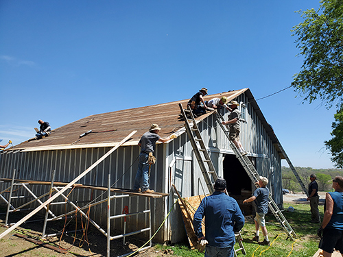 Knights from Councils 1966, 3152 and 7021 repair a barn for the Franciscan Sisters of the Sorrowful Mother in Nebraska City. Photo courtesy of Michael Vaughn