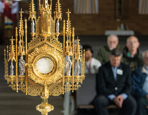 Knights and other parishioners participate in a Holy Hour at Sacred Heart Catholic Church in Lacey, Wash., on May 6. The century-old monstrance was restored last year through the efforts of Father Nicholas Rausch, OSB Council 1643 in Lacey. (Photo by M. Scott Brauer)