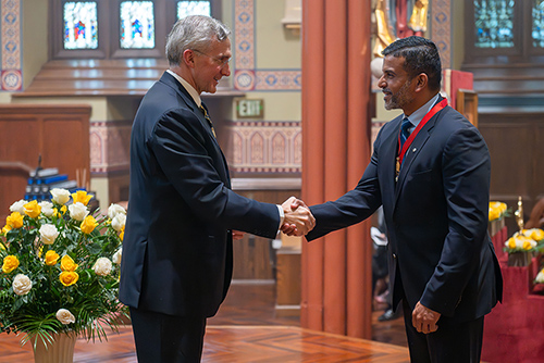 State Deputy Savio Dias of Prince Edward Island shakes hands with Supreme Knight Patrick Kelly after receiving his medal of office during a ceremony at the conclusion of Mass at St. Mary’s Church in New Haven, Conn., June 7. (Photo by Tamino Petelinšek)