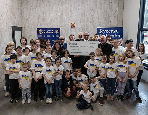 Polish Knights, including Supreme Warden Andrzej Anasiak and State Chaplain Archbishop Wacław Depo of Częstochowa, present a donation of CA$5,000 from Ontario Knights at the orphanage for Ukrainian children in Częstochowa run by Caritas. (Photo by Karol Porwich)