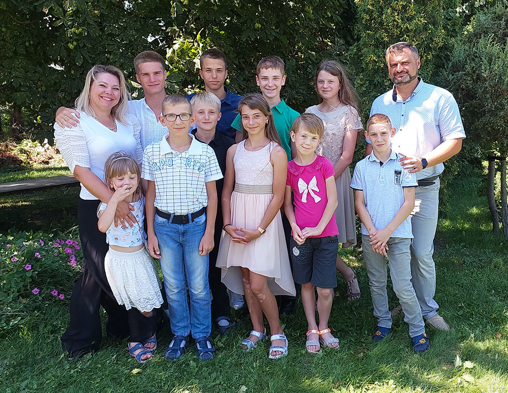 Ukraine State Secretary Oleksandr Brunevych and his wife, Svetlana, are pictured with their family, including their five foster children.