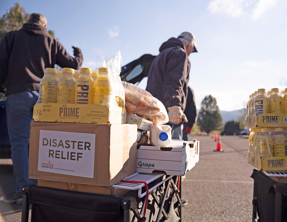 Knights sort milk, bread and other food outside St. Anthony Catholic Church on Oct. 17. Parish groups, including the Knights of Columbus round table, have been receiving and giving out supplies every day for several weeks. (Photo by Castletown Media)