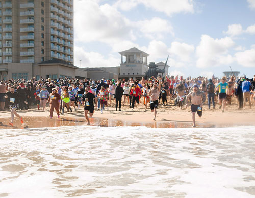 More than 3,000 people, including Knights, family members and friends representing 44 Virginia councils, run into the Atlantic Ocean at Virginia Beach during the Special Olympics Virginia Polar Plunge Festival Feb. 3. (Courtesy of Special Olympics Virginia) 