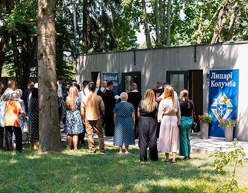 Father Lubomyr Yavorsky, director of Mudra Sprava, blesses a modular home for internally displaced persons in Briukhovychi, Ukraine, July 12.