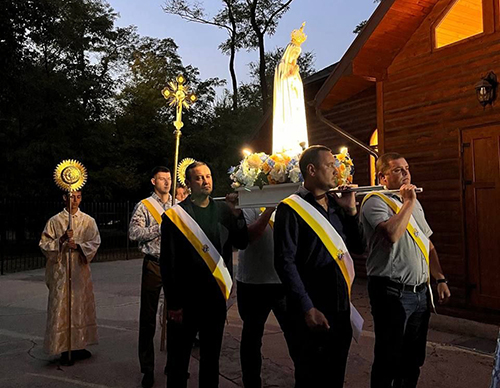 Knights from St. Volodymyr Council 18319 in Zaporizhzhia, Ukraine, carry a statue of Our Lady of Fatima, Oct. 31, 2023, during a prayer vigil at St. Volodymyr Parish. Father Bohomaz brought the statue to about 30 parishes in eastern Ukraine as part of an evangelization mission in which he preached Marian devotion and the rosary.