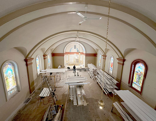 Workers are seen restoring the interior of St. Edward Church in Elmdale, Minn. The church’s sacristy was destroyed and part of its sanctuary was damaged; and the rest of the building sustained damage from smoke and water. (OSV News photo/Dianne Towalski, The Central Minnesota Catholic)